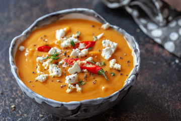 Roasted pumpkin and carrot soup with feta cheese and chili pepper