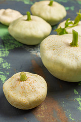 White squash vegetables on old iron background