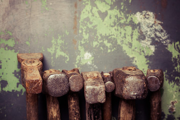 set of old hammers and rusty nails. tools on metal the surface.