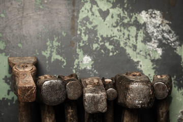 set of old hammers and rusty nails. tools on metal the surface.