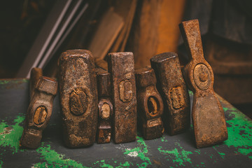 set of old hammers and rusty nails. tools on metal the surface.