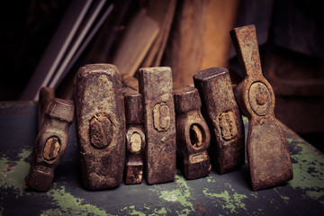 set of old hammers and rusty nails. tools on metal the surface.