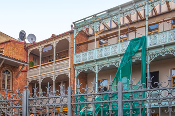 Facades of houses with carved wooden railings