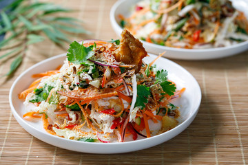 Thai salad with fresh vegetables, poached chicken and crispy chicken skin