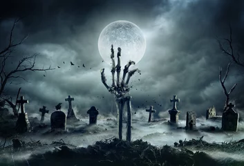 Foto op Plexiglas Skeleton Zombie Hand Rising Out Of A GraveYard - Halloween © Romolo Tavani