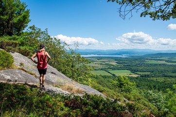 Fototapeta premium woman taking in the view from Boquet mountain trail