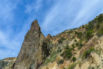 Pointed rock shot against a cloudy sky