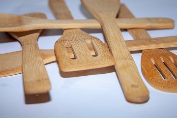 healthy light wooden kitchenware on a white background