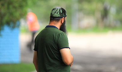 muslim man walks in the park