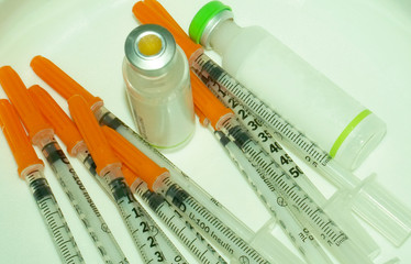 Diabetes patient shot by syringe with dose of insulin, subabdomen vaccination isolated on a white background.   