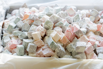 Turkish delight with nuts, pistachios, coconut, chocolate and rose leaves in the box. Rahat lokum, traditional Turkish sweets, Turkey.