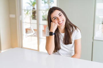 Beautiful young brunette woman smiling cheerful looking at the camera with a big smile on face showing teeth