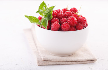 fresh raspberries with mint in a white Cup