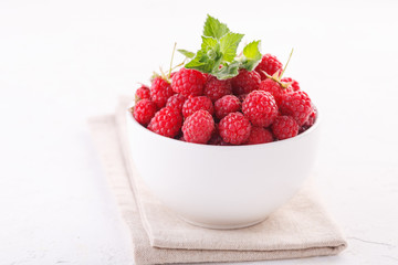 fresh raspberries with mint in a white Cup