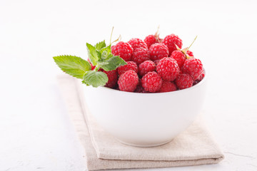 fresh raspberries with mint in a white Cup