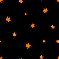 Seamless Halloween pattern with maple leaves on black background.