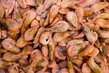 Frozen shrimps in one huge pile, seafood background for sustainable healthy diet.