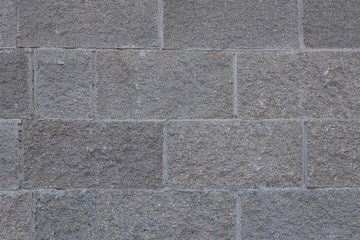 Front view of grey brick wall texture background. Tiled concrete cement surface.