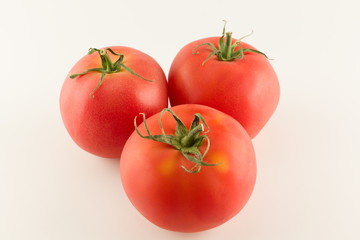 ripe red varietal tomatoes isolated