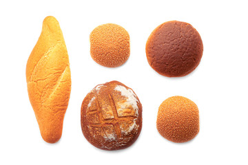 Flat lay group of different kinds of tasty fresh baked bread isolated on white background