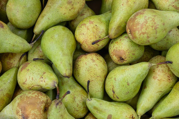 Green freshly-harvested ripe pear pile, fruit pear close-up for background, healthy snack, diet