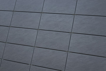 Dark gray tiled wall on building facade, exterior design option