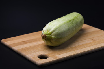 Squash. Green zucchini on a black background.Yellow squash. Cooking from zucchini.