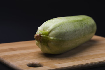 Squash. Green zucchini on a black background.Yellow squash. Cooking from zucchini.