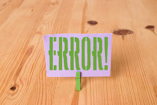 Writing note showing Error. Business concept for state or condition of being wrong in conduct judgement or program Wooden floor background green clothespin groove slot office