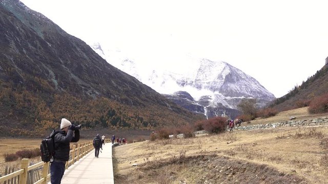Daocheng, China - 10/28/2018 ; Tourists are enjoying with  beautiful nature in yading nature reserve, China