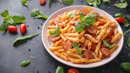 Sausage penne Pasta with tomato sauce and fresh herbs