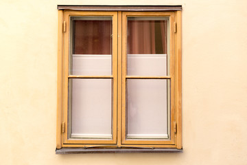 Simple wood window on the yellow wall