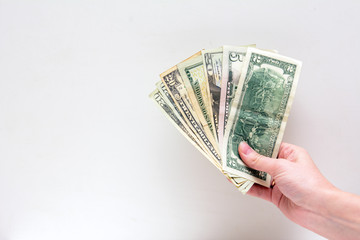 In a female hand a pack of dollars on a white background. Concept - financial success
