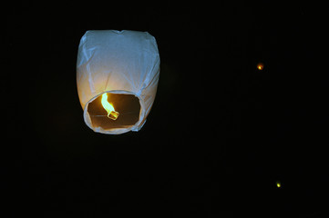 A flashlight of happiness flies in the night sky.
