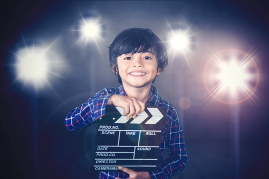 Child holds clapperboard during film production