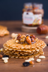 Tasty and healthy honey with nuts on the table.