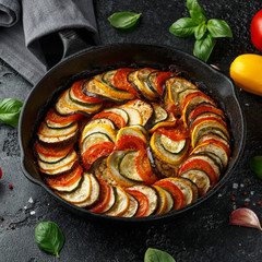 Ratatouille Vegetable Stew with zucchini, eggplants, tomatoes, garlic, onion and basil. on cast iron pan. Traditional French food.