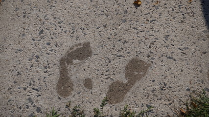 Barefeet on wet cement