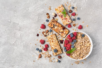 Oat flakes with fresh berries and granola bar for healthy breakfast