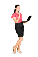 Female employee standing in studio with laptop