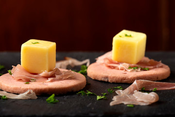 Finger food - raspberry biscuit with cheese and smoked meat