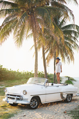 Happy young woman and retro convertible car