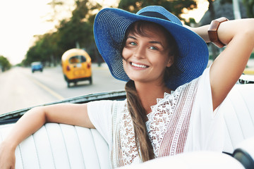 Happy young woman and retro convertible car