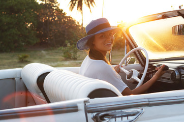 Happy young woman and retro convertible car