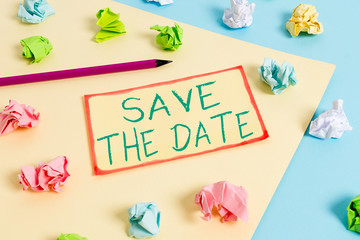 Writing note showing Save The Date question. Business concept for asking someone to remember specific day or time Colored crumpled papers empty reminder blue yellow clothespin