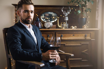 Handsome bearded man with a glass of red wine