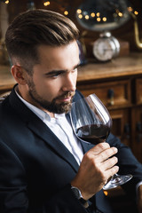 Handsome bearded man with a glass of red wine