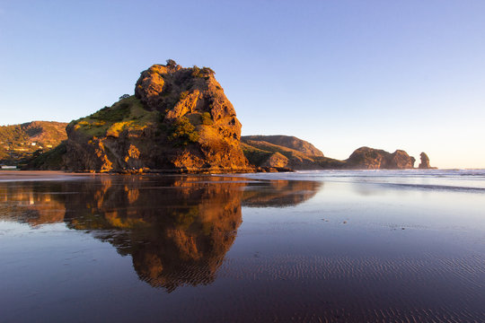 beautiful sunset at Piha beach, New Zealand