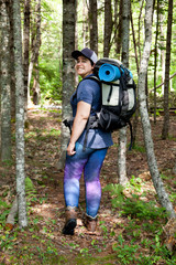 Woman looking back while heading hiking