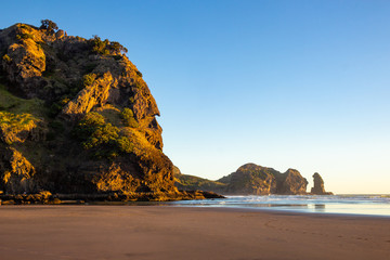 beautiful sunset at Piha beach, New Zealand